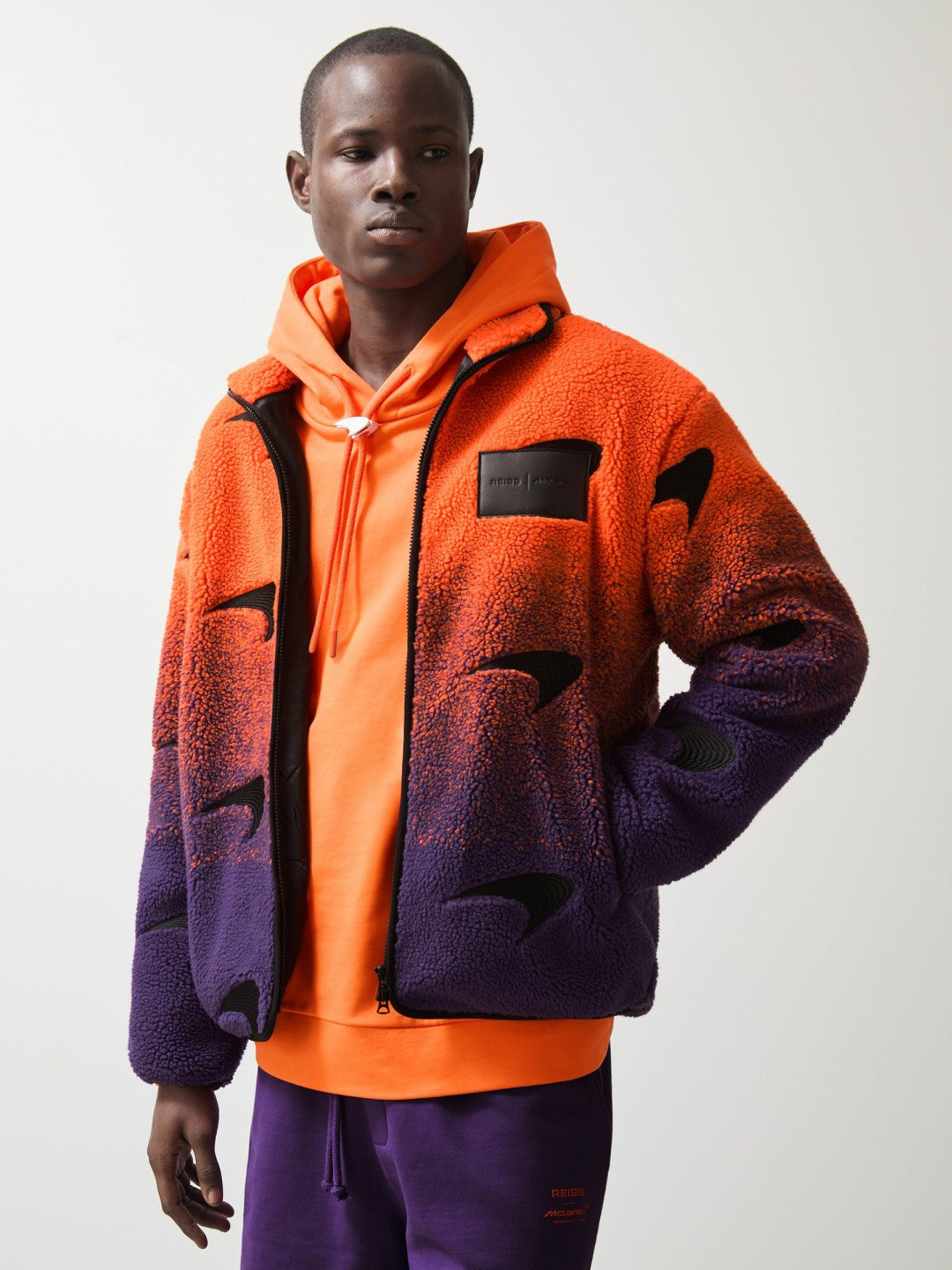 Unisex Fit McLaren F1 Team Ombré Fleece Jacket in Papaya Orange/Purple | Reiss Near Me